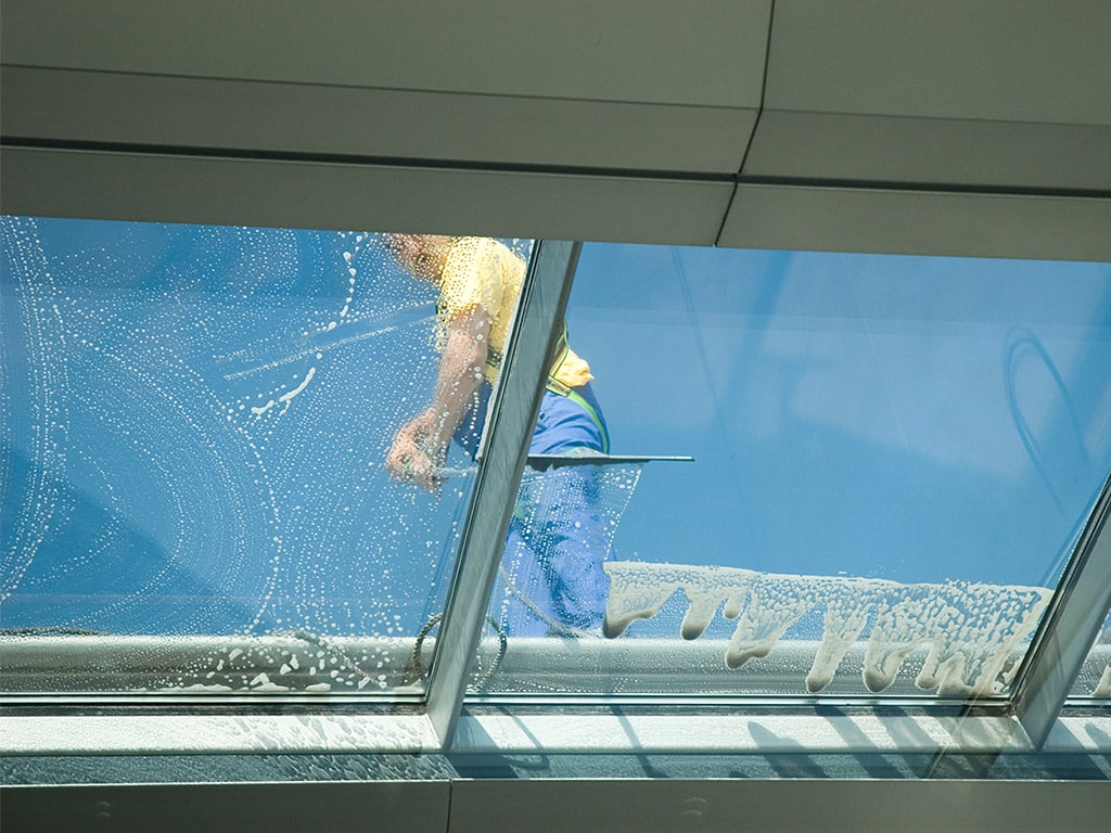 worker cleaning window